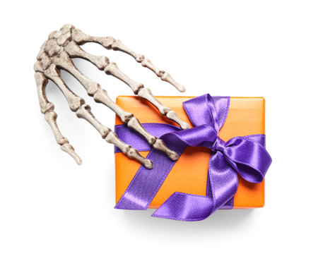 Skeleton hand and gift box for Halloween on white backgroundの写真素材