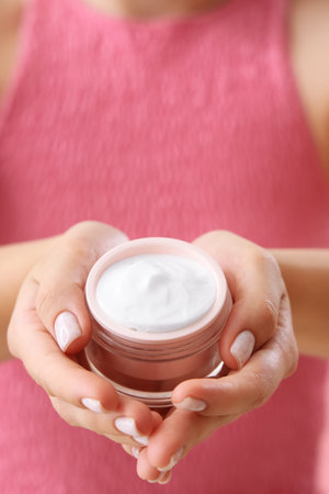 Young woman with cosmetic cream, closeupの写真素材