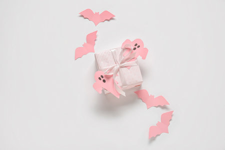Composition with beautiful gift box and Halloween decor on white backgroundの写真素材