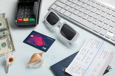 Composition with stylish sunglasses, credit card, keyboard and tickets on light backgroundの写真素材