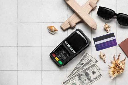 Composition with credit card, payment terminal, money and wooden plane on light tile backgroundの写真素材
