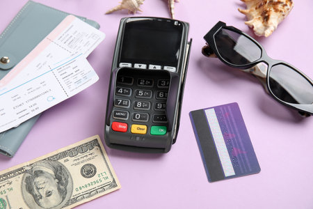 Payment terminal, credit card, tickets and sunglasses on lilac backgroundの写真素材