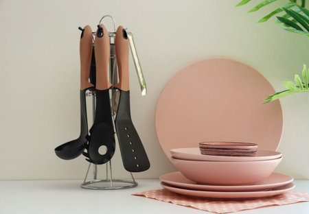 Clean dishes and kitchen utensils on white counter, closeupの写真素材