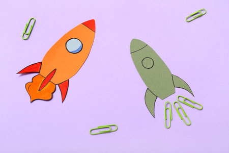 Paper rockets with clips on purple backgroundの写真素材