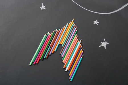 Pencils and drawn stars on black backgroundの写真素材