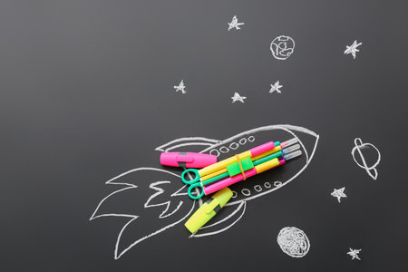Drawn rocket with stationery on black backgroundの写真素材