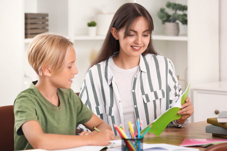 Little boy doing lessons with his mother at home
