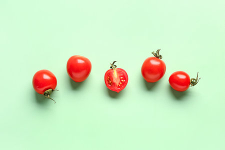 Fresh cherry tomatoes on green backgroundの写真素材