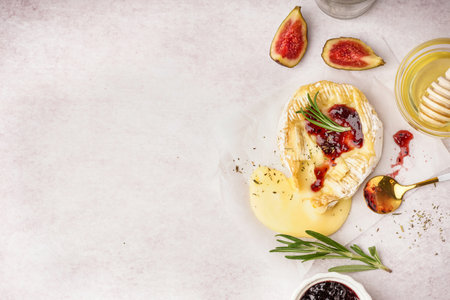 Tasty baked camembert cheese on light backgroundの写真素材