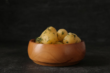 Bowl with boiled baby potatoes on black backgroundの写真素材