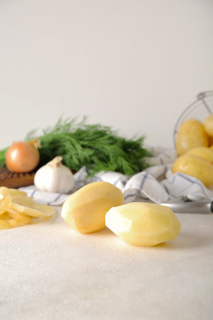 Peeled potatoes on light backgroundの写真素材
