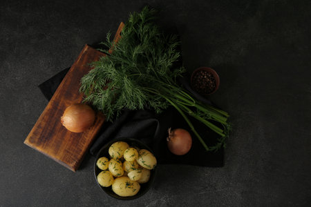Bowl with boiled baby potatoes on black backgroundの写真素材