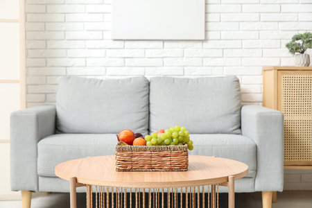 Wicker fruit basket on coffee table in living roomの写真素材