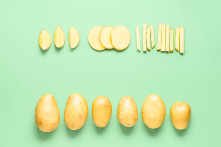 Frame made of raw potatoes on green backgroundの写真素材