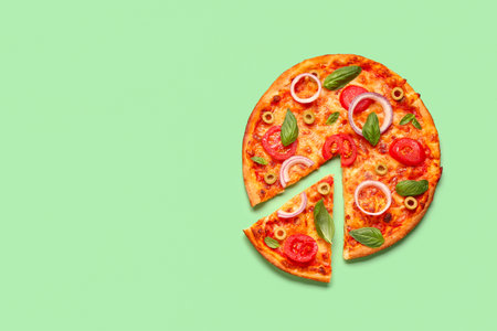 Tasty pizza with olives, tomatoes and basil on green backgroundの写真素材