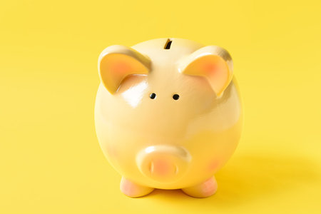 Piggy bank on yellow backgroundの写真素材