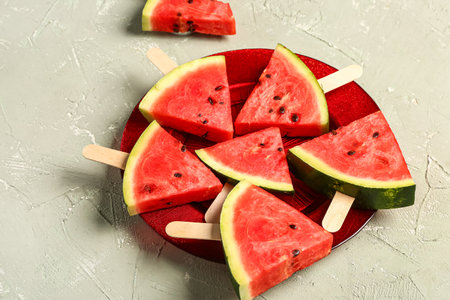Plate with sweet watermelon sticks on gray backgroundの写真素材