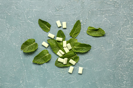 Fresh chewing gums with mint on blue background