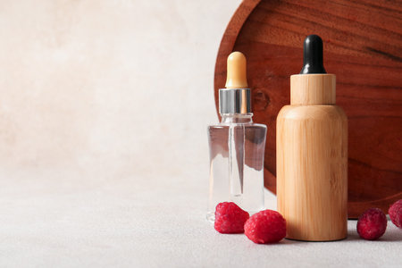 Bottles of cosmetic raspberry oil on white backgroundの写真素材
