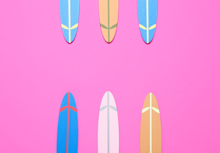 Different mini surfboards on pink backgroundの写真素材