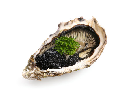 Tasty oyster with black caviar on white backgroundの写真素材