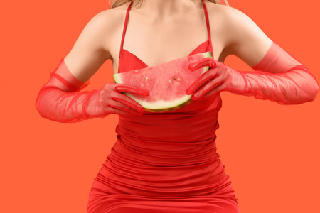 Young woman with fresh watermelon on red background, closeupの写真素材