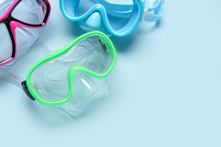 Different swimming masks on blue background