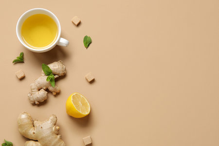 Cup of ginger tea with lemon and mint on brown backgroundの写真素材