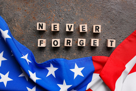 Wooden blocks with inscription in memory of National Day of Prayer and Remembrance for the Victims of the Terrorist Attacks on grunge brown backgroundの写真素材