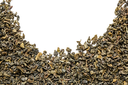 Frame made of dry green tea leaves on white background