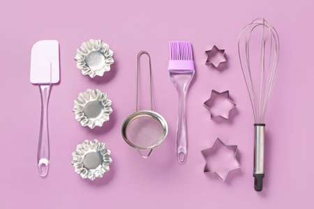 Baking utensils on pink background