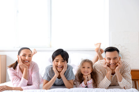 Little children with their parents in the bedroom