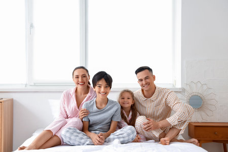 Little children with their parents in the bedroomの写真素材