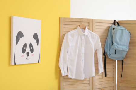 Stylish school uniform hanging in the roomの写真素材