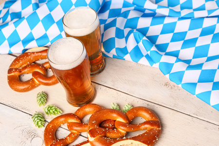 Flag of Bavaria, mugs with beer and pretzels on white wooden backgroundの写真素材