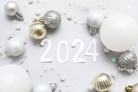 Figure 2024 made of paper and Christmas decorations on gray backgroundの写真素材