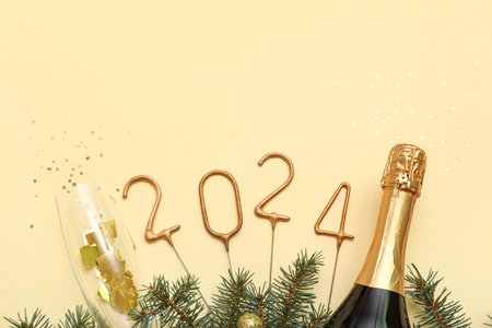 Figure 2024 made of sparklers with Christmas decorations, champagne and fir branches on beige...