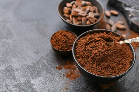 Bowls with cocoa powder on black backgroundの写真素材