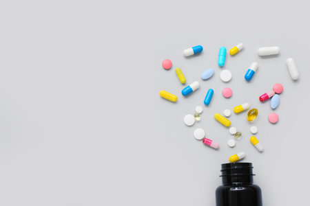 Composition with bottle and different pills on gray backgroundの写真素材