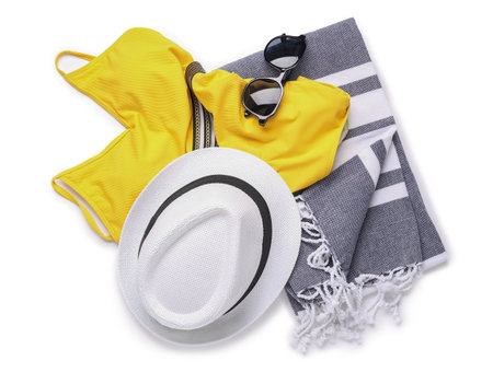 Stylish beach hat, swimsuit, sunglasses and towel on white backgroundの写真素材