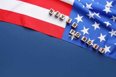 Wooden blocks with inscription in memory of National Day of Prayer and Remembrance for the Victims of the Terrorist Attacks on blue backgroundの写真素材