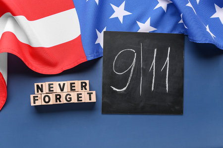 USA flag and card with date of National Day of Prayer and Remembrance for the Victims of the Terrorist Attacks on blue backgroundの写真素材