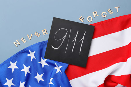 USA flag and card with date of National Day of Prayer and Remembrance for the Victims of the Terrorist Attacks on gray backgroundの写真素材