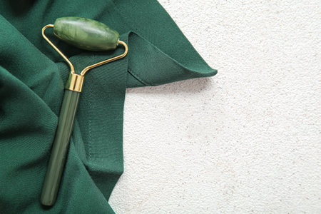 Stone face massage roller with cloth on light backgroundの写真素材