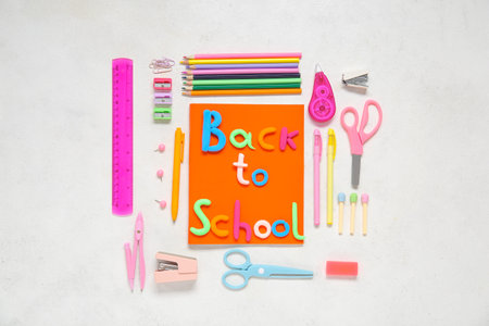 Text BACK TO SCHOOL and stationery on light backgroundの写真素材