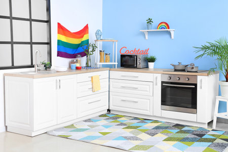 Interior of kitchen with hanging LGBT flag and countersの写真素材