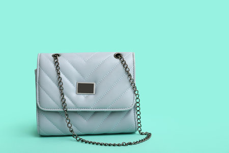 Stylish blue chain bag on turquoise backgroundの写真素材