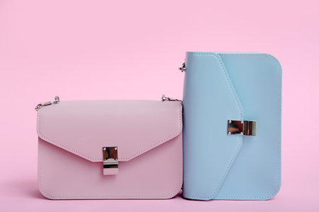 Different stylish bags on pink backgroundの写真素材