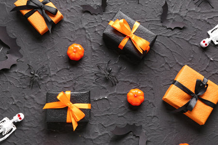 Gift boxes with Halloween decorations on grunge black backgroundの写真素材