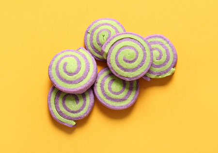 Tasty cookies for Halloween celebration on yellow backgroundの写真素材